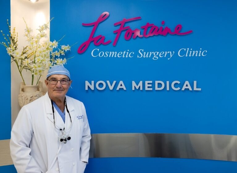 A man in front of a sign for a cosmetic surgery clinic.