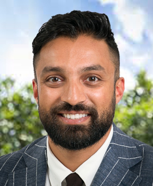 A man with a beard and suit jacket