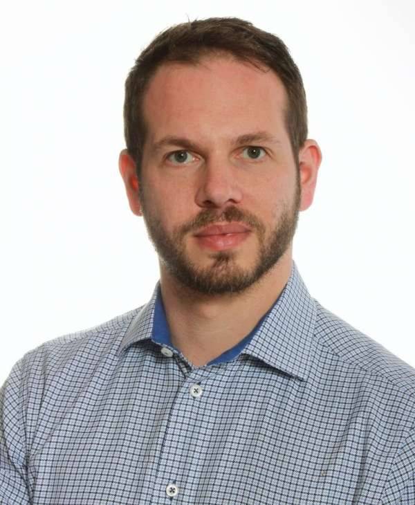 A man with a beard and blue shirt