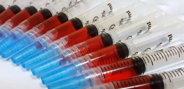 A close up of many syringes in a row