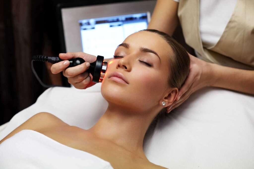 A woman getting her face cleaned by an esthetician. Laser hair removal Laser hair removal Toronto Hair removal treatment Permanent hair removal Laser hair reduction Facial hair removal Body hair removal Professional laser hair removal Hair-free skin Laser hair removal results