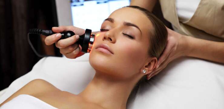 A woman getting her face cleaned by an esthetician. Laser hair removal Laser hair removal Toronto Hair removal treatment Permanent hair removal Laser hair reduction Facial hair removal Body hair removal Professional laser hair removal Hair-free skin Laser hair removal results