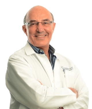 A man in white lab coat with arms crossed.